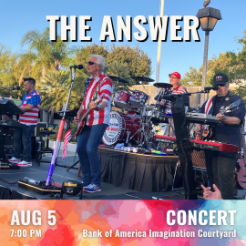 A live outdoor band performance takes place on a raised stage surrounded by palm trees and evening light. Several band members wearing red, white, and blue clothing play guitars, keyboards, and drums. A large drum kit with the band’s logo sits at center stage. Overhead, bold text reads “THE ANSWER.” A colorful banner along the bottom displays event details: AUG 5, 7:00 PM, CONCERT, Bank of America Imagination Courtyard.